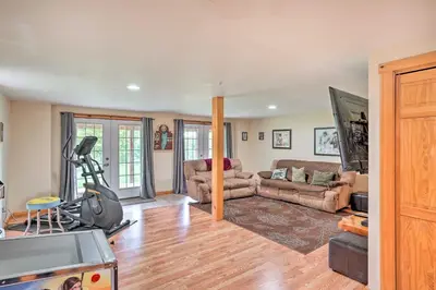 a living room with a couch and a gym at Grand Windham Retreat with Fire Pit and Game Room in Windham