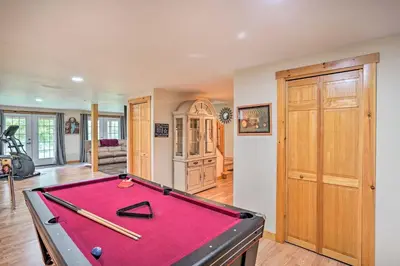 a pool table in a living room with a pool table at Grand Windham Retreat with Fire Pit and Game Room in Windham