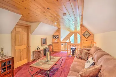 a living room with a couch and a table at Grand Windham Retreat with Fire Pit and Game Room in Windham