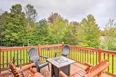 two chairs and a table on a wooden deck at Grand Windham Retreat with Fire Pit and Game Room in Windham