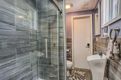 a bathroom with a glass shower and a toilet at Stunning South Fallsburg Home with Pool and Deck! in South Fallsburg