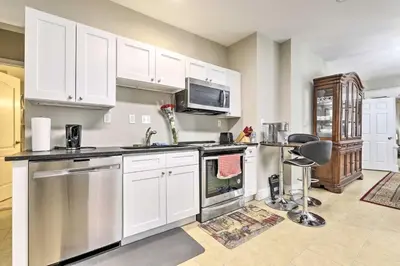 a kitchen with white cabinets and stainless steel appliances at 2 Mi to Downtown Springfield Apt with Balcony! in Springfield