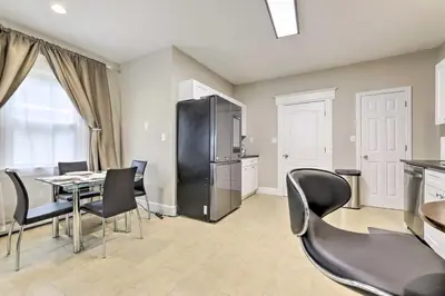 a dining room with a table and chairs and a refrigerator at 2 Mi to Downtown Springfield Apt with Balcony! in Springfield