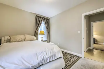 a bedroom with a white bed and a window at 2 Mi to Downtown Springfield Apt with Balcony! in Springfield