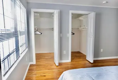a bedroom with a door leading to a closet at Urban Oasis Spacious 3BR 2BA Patio Near NYC EWR American Dream Mall in Newark