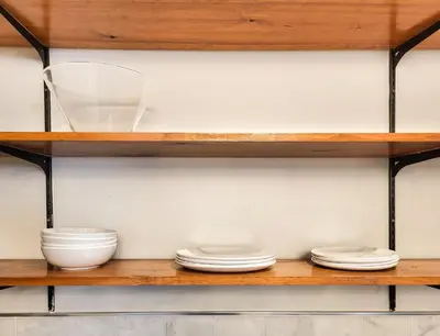 a wooden shelf with bowls and plates on it at Beautiful Wooster Sq. getaway - great neighborhood in New Haven