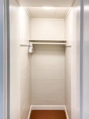 a walk in closet with white walls and shelves at Beautiful Wooster Sq. getaway - great neighborhood in New Haven
