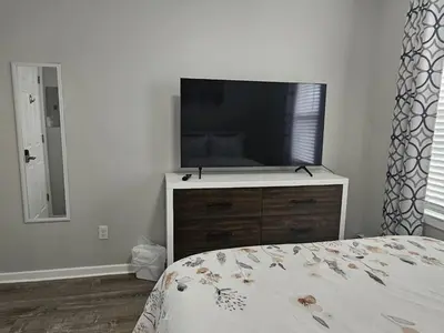 a bedroom with a flat screen tv on a dresser at 1 Bedroom Apartment in Hartford
