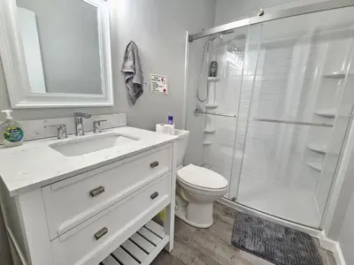 a bathroom with a shower and a sink and a toilet at 1 Bedroom Apartment in Hartford