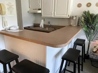 a kitchen with a counter with stools and a sink at Gorgeous New Zen Suite Sleeps 4-Ski On Off Jiminy in Hancock
