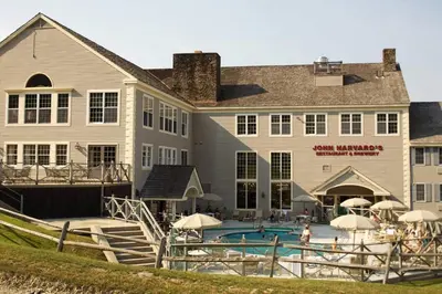 a large building with a swimming pool in front of it at Gorgeous New Zen Suite Sleeps 4-Ski On Off Jiminy in Hancock