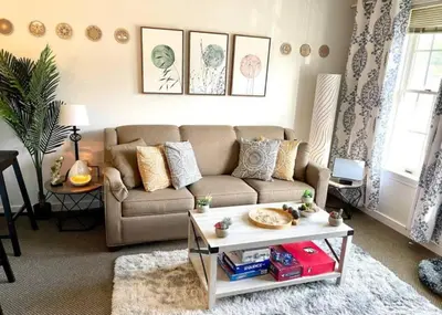 a living room with a couch and a table at Gorgeous New Zen Suite Sleeps 4-Ski On Off Jiminy in Hancock