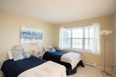 a bedroom with two beds and a window at Spacious 3BR 3BA Sleeps 8 Ski On Off Jiminy Mountain Resort in Hancock