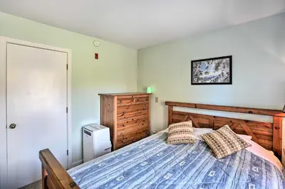 a bedroom with a bed and a dresser at Comfortable Dover Apartment Walk to Mt Snow! in Dover
