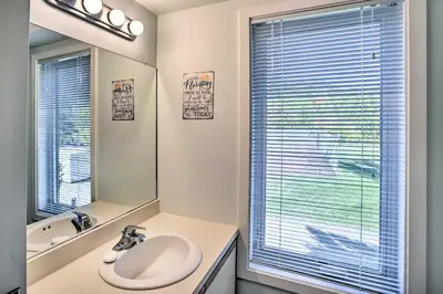a white bathroom with a sink and a mirror at Comfortable Dover Apartment Walk to Mt Snow! in Dover