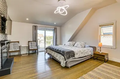 a bedroom with a bed and a fireplace at Near Yale and Lighthouse Point Beach Home with Pool! in New Haven
