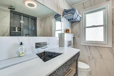 a bathroom with a sink and a toilet at Near Yale and Lighthouse Point Beach Home with Pool! in New Haven
