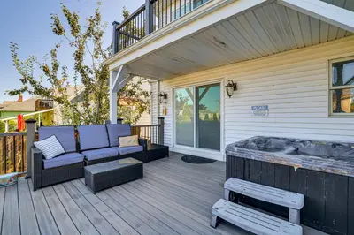 a deck with a couch and a hot tub at Near Yale and Lighthouse Point Beach Home with Pool! in New Haven