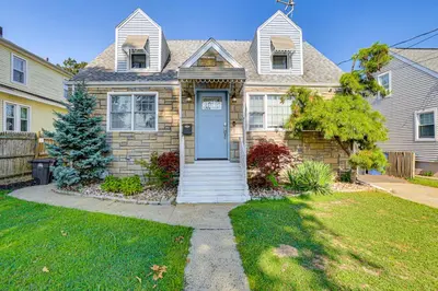 a house with a blue door in a yard at Near Yale and Lighthouse Point Beach Home with Pool! in New Haven