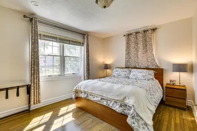 a bedroom with a bed and a window at Near Yale and Lighthouse Point Beach Home with Pool! in New Haven