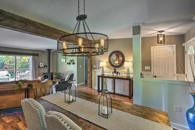 a dining room and living room with a chandelier at Game Room and Spacious Yard 10-Acre Catskills Home! in East Durham
