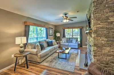 a living room with a couch and a stone wall at Game Room and Spacious Yard 10-Acre Catskills Home! in East Durham