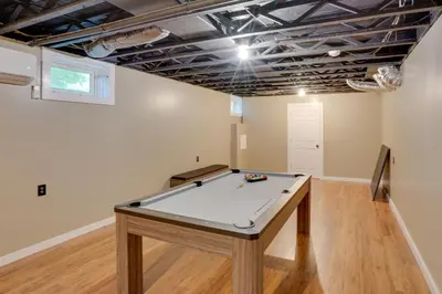 a ping pong table in a room with a ceiling at Game Room and Spacious Yard 10-Acre Catskills Home! in East Durham
