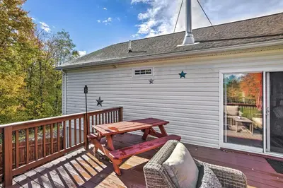 a wooden deck with a table and chairs on a house at Game Room and Spacious Yard 10-Acre Catskills Home! in East Durham
