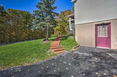 a house with a pink door and a driveway at Game Room and Spacious Yard 10-Acre Catskills Home! in East Durham
