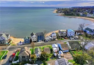 an aerial view of a small town with houses and the water at Beachy Bay Breeze Bungalow 2BR with parking and close to many amenities. in West Haven