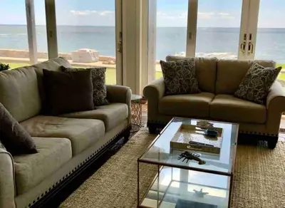 a living room with two couches and a coffee table at Direct Waterfront 4 Bedroom Beach House With Stunning LI Sound Views & Private Beach in Guilford