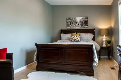 a bedroom with a bed with a wooden frame at Cozy condo with yard and patio. Long-stay discount available in Fairfield