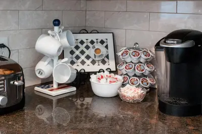 a kitchen counter with a coffee maker and cupcakes at Cozy condo with yard and patio. Long-stay discount available in Fairfield