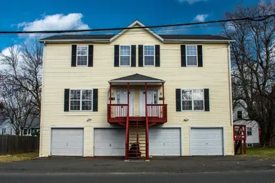 a white house with a red fire escape at Cozy condo with yard and patio. Long-stay discount available in Fairfield