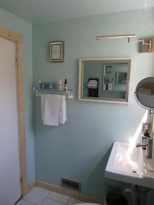 a bathroom with a mirror and a sink at 2 bedroom Apt in Kingston