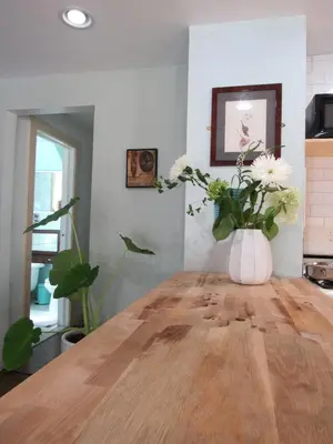 a vase of flowers sitting on a wooden table at 2 bedroom Apt in Kingston