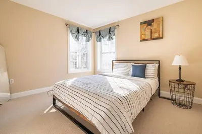 a bedroom with a large bed and a window at Luxury 4 bedroom house in Pocono Mountains with Hottub in Golf Course Near Lake in Tobyhanna