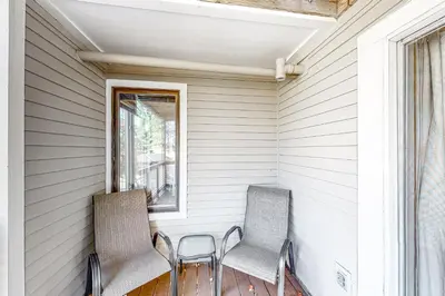 two chairs sitting on a porch with a window at All Season Mountain Retreat in Dover