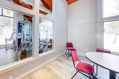 a dining room with a table and chairs and windows at All Season Mountain Retreat in Dover