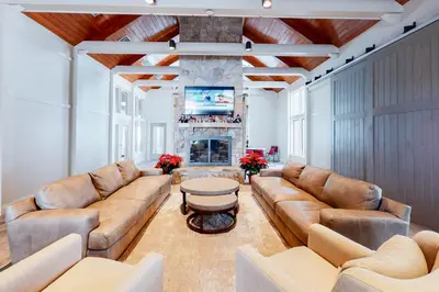 a living room with leather couches and a fireplace at All Season Mountain Retreat in Dover
