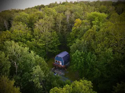 a truck parked in the middle of a forest at Mandy's Mountain Chalet in Dover