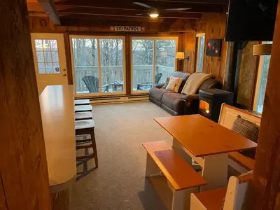 a living room with a couch and a table at Mandy's Mountain Chalet in Dover