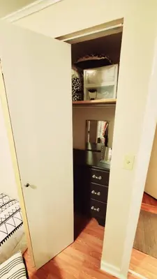a closet with a white door in a room at Black-white Rm By Yale U in New Haven