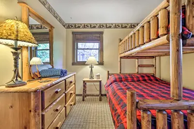 a bedroom with a bunk bed and a desk at Deck and Forest Views Secluded Cresco Cabin! in Cresco