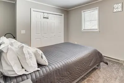 a bedroom with a bed and a window and a door at 4 Mi to Camelback! Group-Friendly Poconos Cabin in Bartonsville