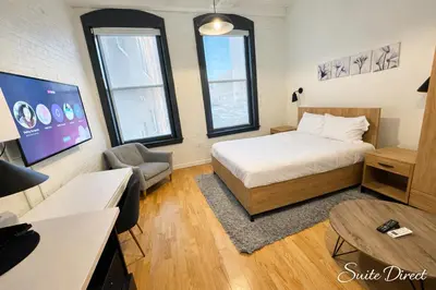 a bedroom with a bed and a desk and a tv at Trumbull Apartments Hartford CT in Hartford