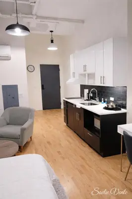 a kitchen with a sink and a couch in a room at Trumbull Apartments Hartford CT in Hartford