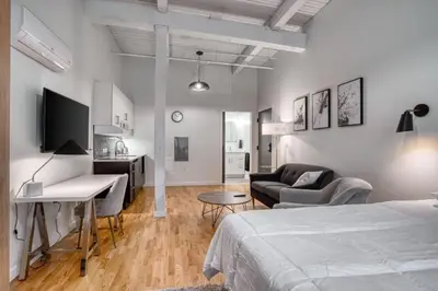 a bedroom with a bed and a desk and a couch at Trumbull Apartments Hartford CT in Hartford