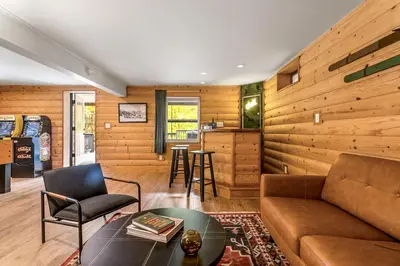 a living room with a couch and a table at Woodpecker House - Mountain retreat with hot tub - 10 min to skiing in Hunter & Windham in Jewett