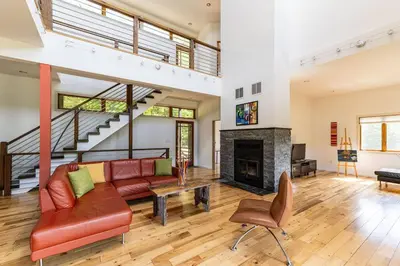 a living room with a couch and a fireplace at Stone Ledge in Margaretville